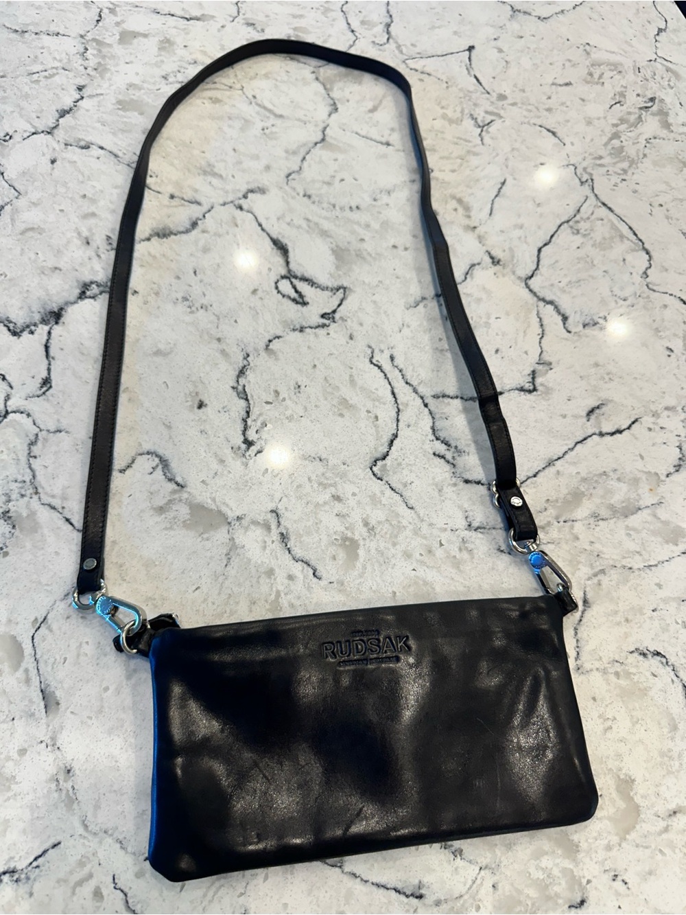 RUDSAK Black Leather Crossbody Pouch with Adjustable Strap